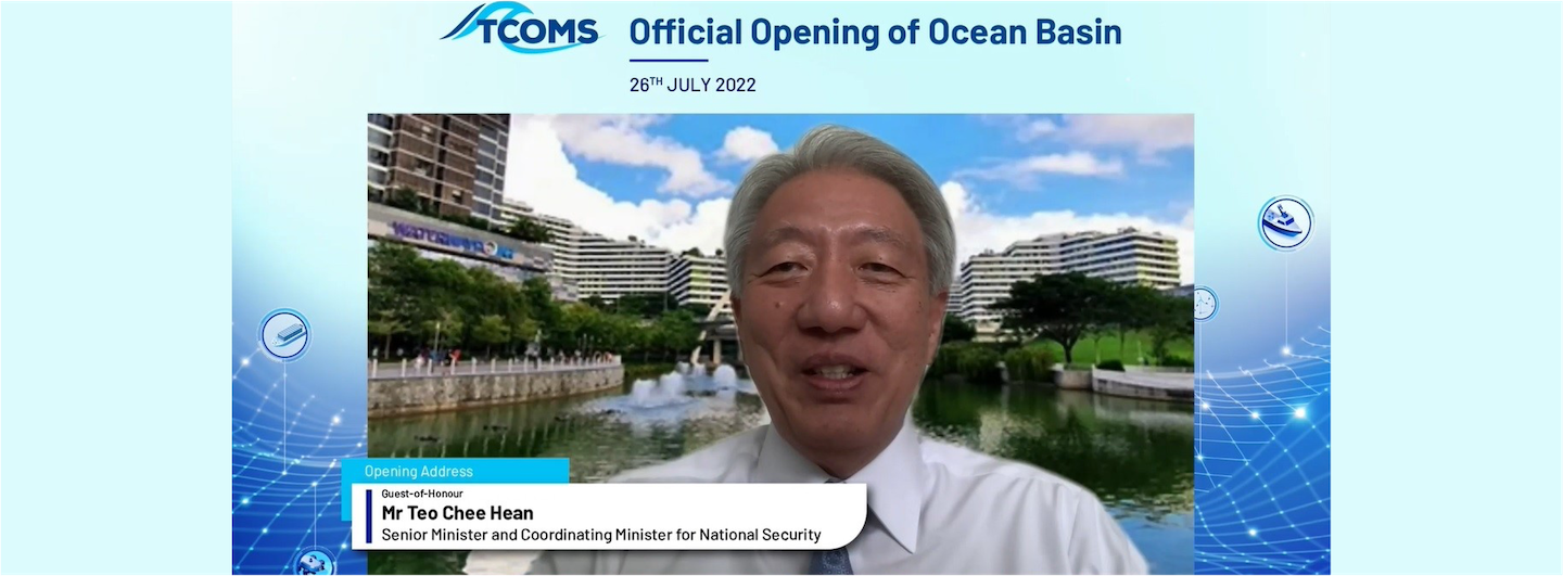 TCOMS Official Opening; Mr. Teo Chee Hean speaking via video call, water and buildings in background.